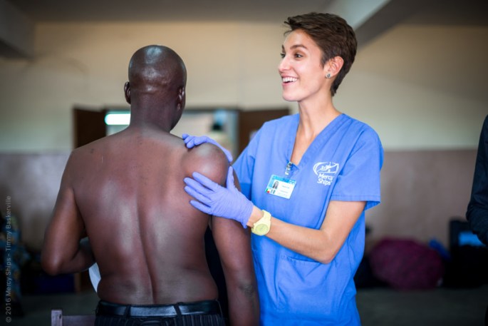 Nurse Kayla Innis examining patient during screening process.